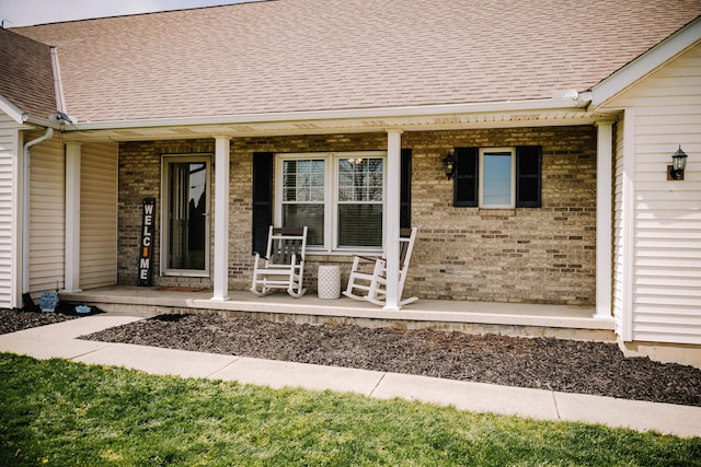 17920 Miller Rd, Richwood, OH 43344 - doorway to property featuring brick siding, a shingled roof, and covered porch