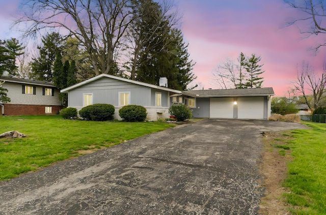 3318 Darbyshire Dr, Hilliard, OH 43026 - ranch-style house featuring a chimney, an attached garage, driveway, and a yard