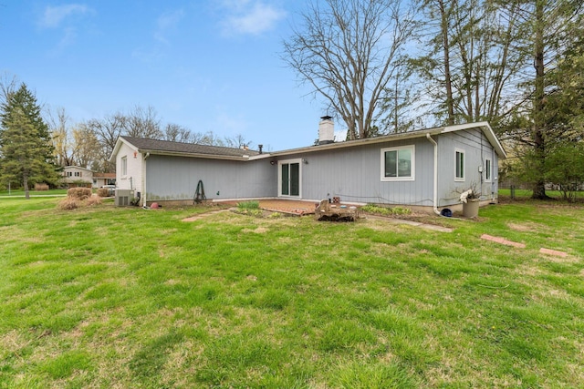 3318 Darbyshire Dr, Hilliard, OH 43026 - back of house featuring a lawn, a chimney, and a patio