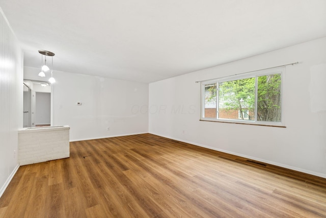 3318 Darbyshire Dr, Hilliard, OH 43026 - unfurnished living room featuring wood finished floors, visible vents, and baseboards