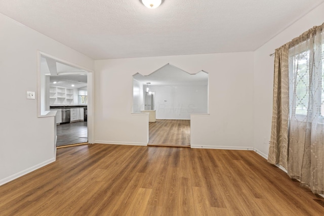 3318 Darbyshire Dr, Hilliard, OH 43026 - spare room featuring arched walkways, baseboards, and wood finished floors