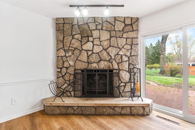 3318 Darbyshire Dr, Hilliard, OH 43026 - details with track lighting, wood finished floors, visible vents, baseboards, and a fireplace