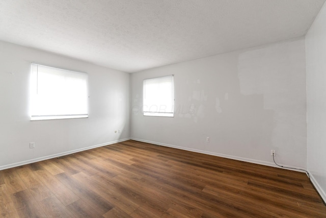 3318 Darbyshire Dr, Hilliard, OH 43026 - spare room featuring visible vents, baseboards, dark wood-style floors, and a textured ceiling