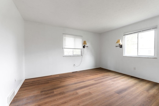 3318 Darbyshire Dr, Hilliard, OH 43026 - unfurnished room featuring wood finished floors, visible vents, and a wealth of natural light