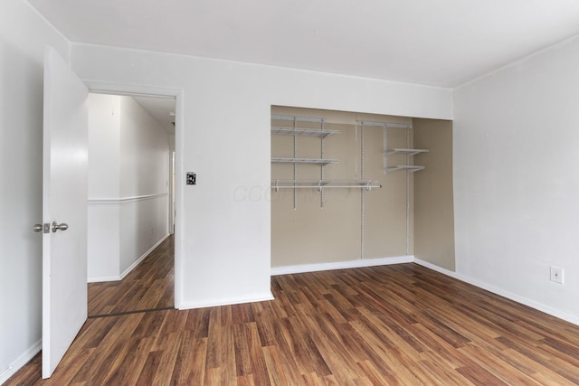 3318 Darbyshire Dr, Hilliard, OH 43026 - unfurnished bedroom with baseboards, wood finished floors, and a closet