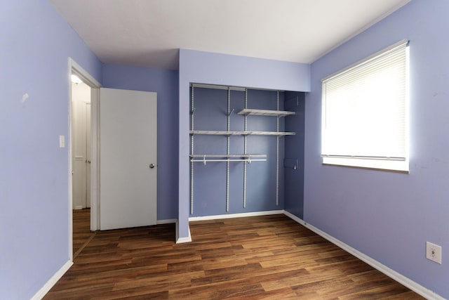 3318 Darbyshire Dr, Hilliard, OH 43026 - unfurnished bedroom with baseboards, wood finished floors, and a closet