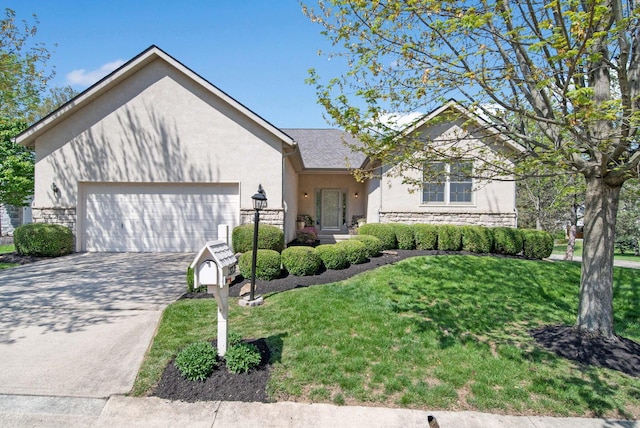 2882 Kool Air Way, Columbus, OH 43231 - single story home featuring a front lawn, driveway, stone siding, a garage, and stucco siding