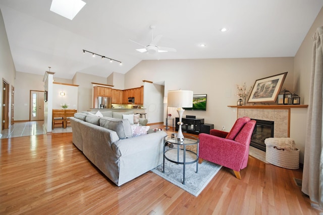 2882 Kool Air Way, Columbus, OH 43231 - living room featuring a skylight, light wood-style flooring, track lighting, and a fireplace
