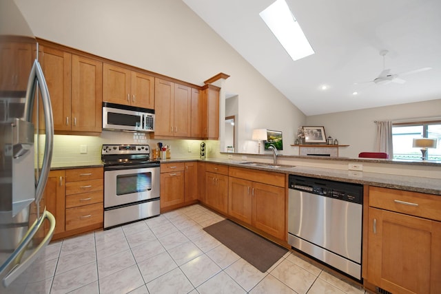 2882 Kool Air Way, Columbus, OH 43231 - kitchen with backsplash, stone countertops, a sink, appliances with stainless steel finishes, and high vaulted ceiling