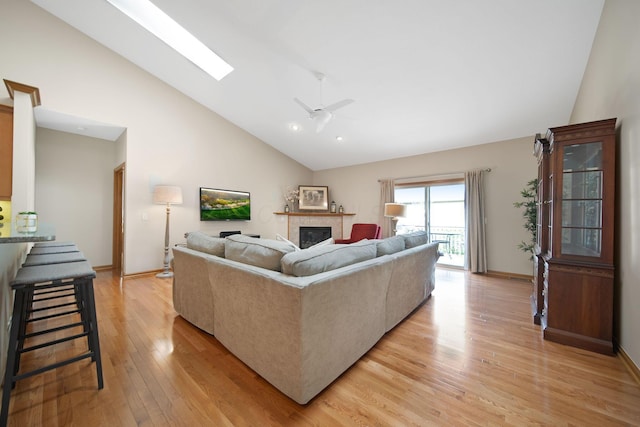 2882 Kool Air Way, Columbus, OH 43231 - living room with light wood-style floors, a skylight, baseboards, a fireplace, and high vaulted ceiling