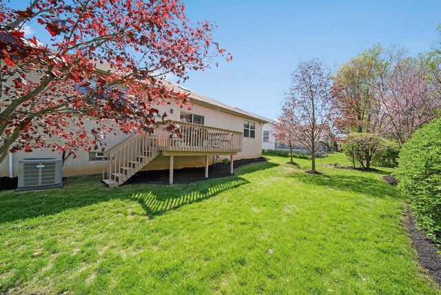 2882 Kool Air Way, Columbus, OH 43231 - rear view of house featuring a lawn, a wooden deck, stairs, and cooling unit