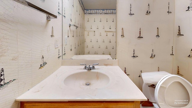 bathroom featuring vanity and toilet