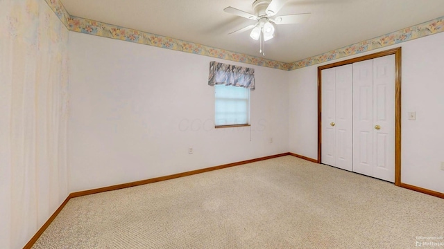 unfurnished bedroom with carpet, a closet, a ceiling fan, and baseboards