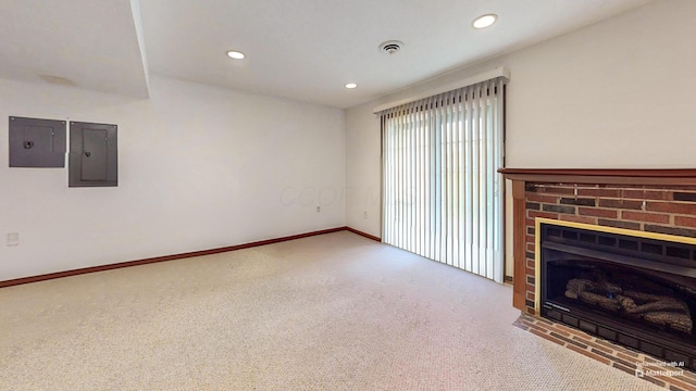 unfurnished living room featuring electric panel, visible vents, carpet floors, and recessed lighting