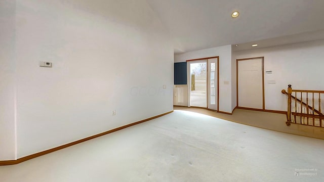 unfurnished room featuring recessed lighting, vaulted ceiling, carpet, and baseboards