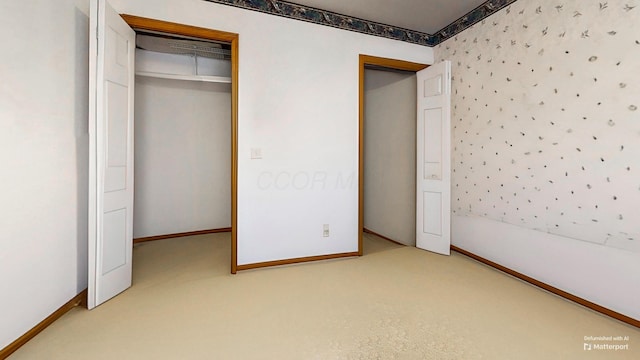 unfurnished bedroom with carpet, baseboards, and a closet