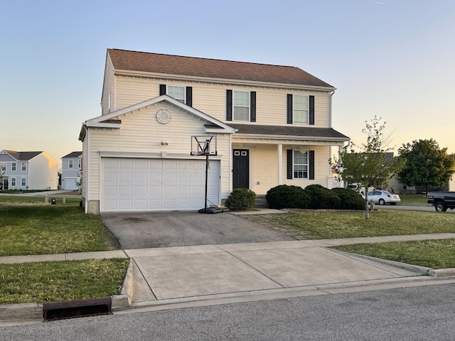 traditional home featuring a porch, a lawn, an attached garage, and aphalt driveway