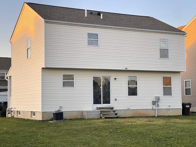 rear view of house featuring a lawn, central air condition unit, and entry steps