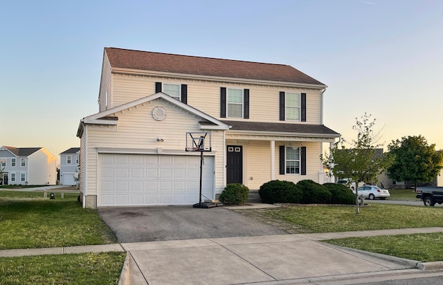 traditional home with driveway, covered porch, an attached garage, and a front lawn
