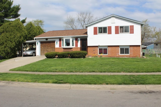 tri-level home with concrete driveway, an attached garage, brick siding, and a front lawn