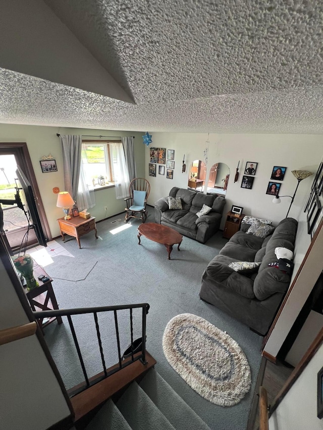 carpeted living room featuring a textured ceiling