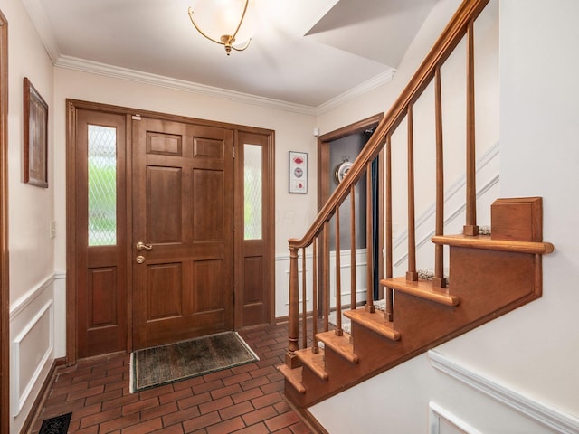 4159 Rowanne Rd, Columbus, OH 43214 - entryway featuring brick floors, stairs, ornamental molding, wainscoting, and a decorative wall