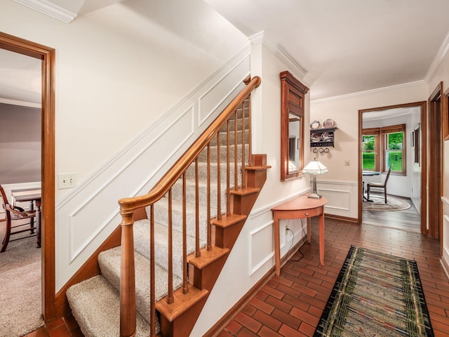 4159 Rowanne Rd, Columbus, OH 43214 - stairs featuring brick flooring, crown molding, a decorative wall, and a wainscoted wall