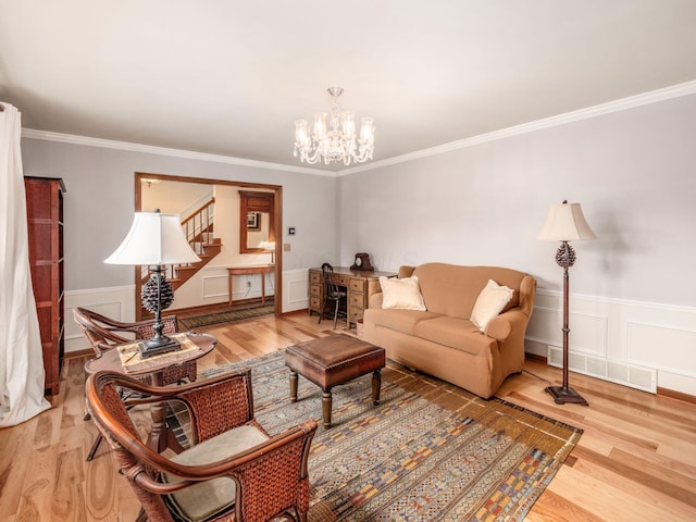 4159 Rowanne Rd, Columbus, OH 43214 - living room with wood finished floors, stairway, a chandelier, ornamental molding, and a wainscoted wall