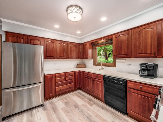 4159 Rowanne Rd, Columbus, OH 43214 - kitchen featuring freestanding refrigerator, black dishwasher, a sink, light countertops, and decorative backsplash