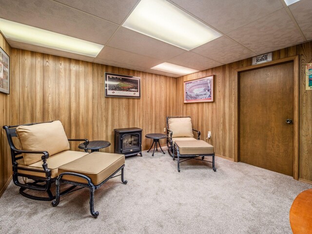4159 Rowanne Rd, Columbus, OH 43214 - sitting room featuring carpet, a paneled ceiling, and wood walls