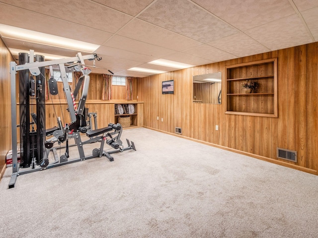 4159 Rowanne Rd, Columbus, OH 43214 - workout area featuring wooden walls, carpet floors, and baseboards