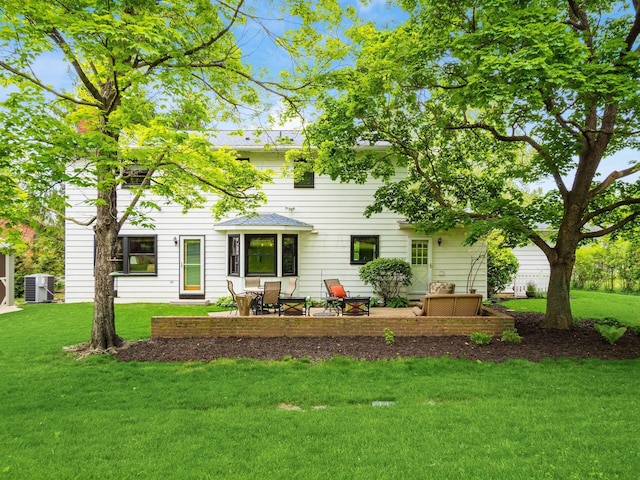 4159 Rowanne Rd, Columbus, OH 43214 - rear view of property featuring central AC, a lawn, and a patio