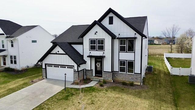 modern farmhouse style home featuring board and batten siding, a shingled roof, concrete driveway, and fence