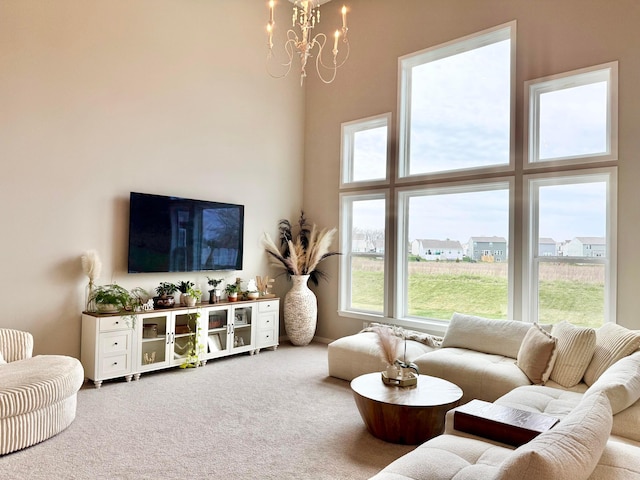 living room with carpet flooring and a chandelier