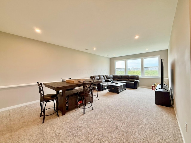 dining area featuring light colored carpet, baseboards, and recessed lighting