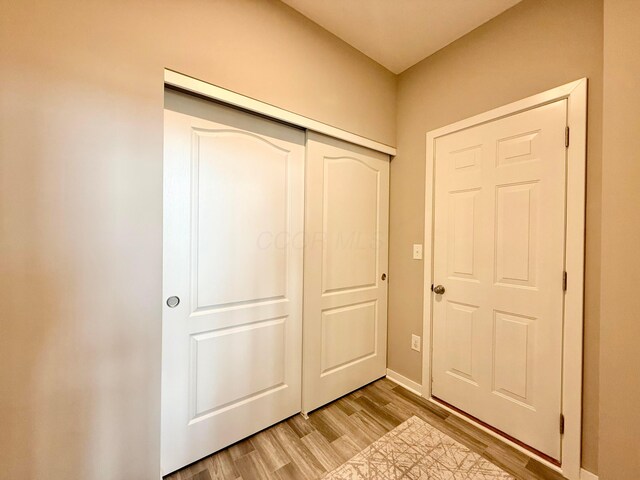 entryway featuring baseboards and light wood finished floors