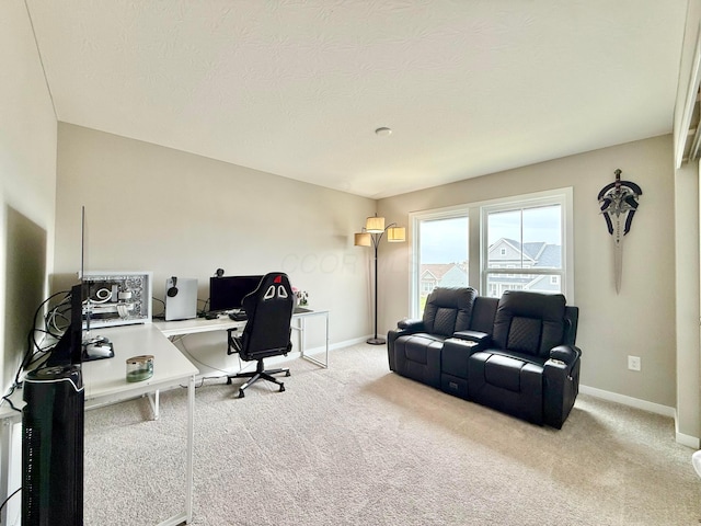office area with baseboards, carpet flooring, and a textured ceiling