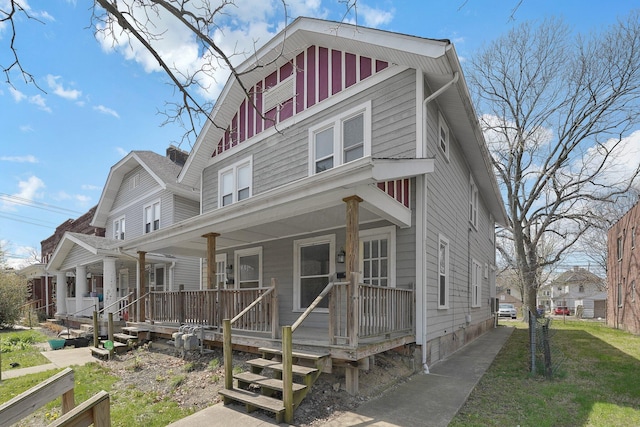 american foursquare style home with covered porch