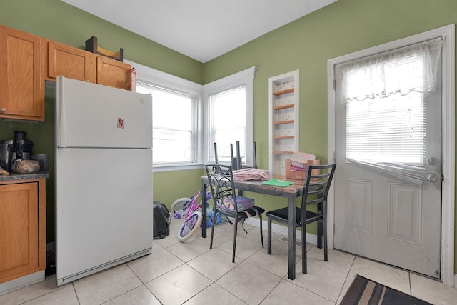 dining space featuring light tile patterned floors