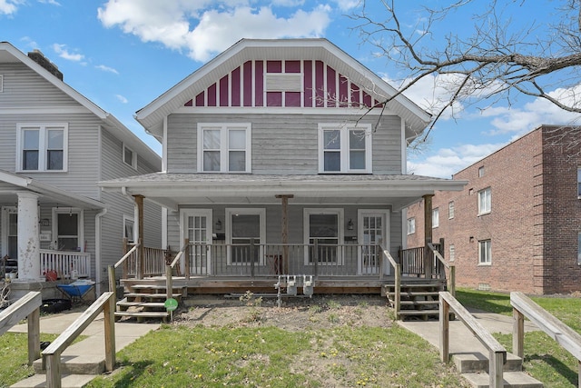american foursquare style home with a porch