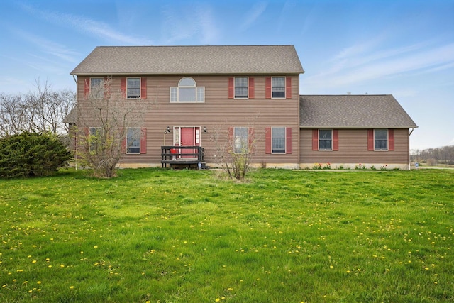 back of house featuring a lawn