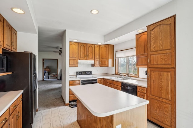 kitchen with range with electric cooktop, light countertops, dishwashing machine, a sink, and black fridge