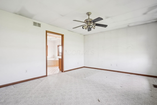 unfurnished room with baseboards, visible vents, carpet flooring, and ceiling fan