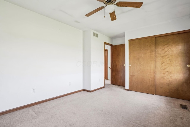 unfurnished bedroom featuring a closet, baseboards, visible vents, and light colored carpet