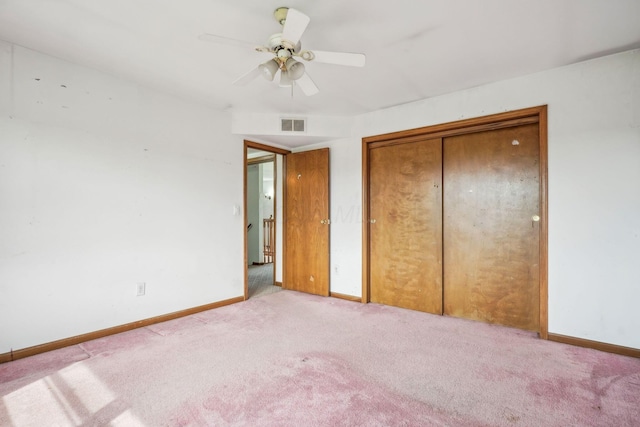 unfurnished bedroom featuring light carpet, a closet, visible vents, and baseboards