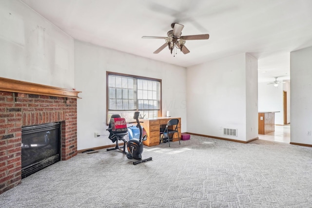 workout area with ceiling fan, carpet, a fireplace, baseboards, and visible vents