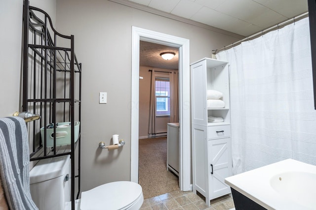 bathroom with a baseboard radiator, vanity, a shower with curtain, baseboards, and toilet