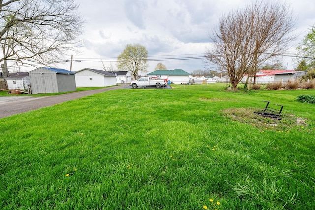 view of yard with an outbuilding and a storage shed