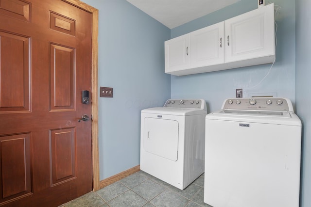 laundry room with light tile patterned flooring, baseboards, washer and clothes dryer, and cabinet space