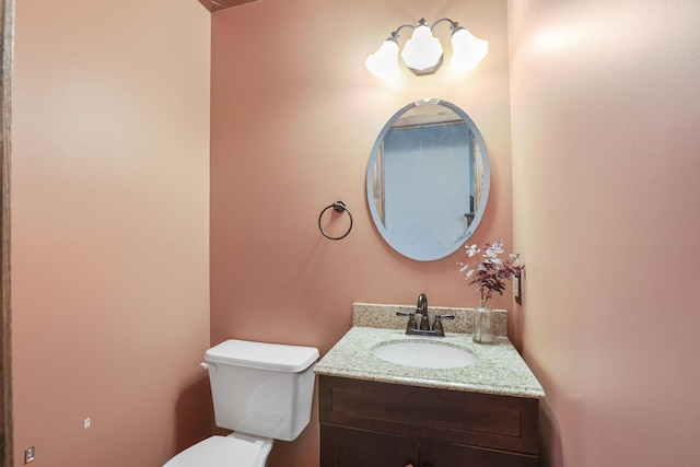bathroom featuring toilet and vanity